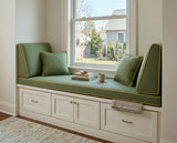 Green seat cushion with angled side backrests and gold piping