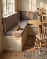 Taupe boucle seat and back cushions on an L-shaped breakfast nook bench