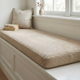 Beige corduroy cushion on a long white window seat