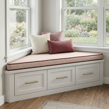 Blush cushion with angled ends on a bay window seat with drawers
