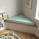 Mint triangle cushion with pink piping on a corner bench in a playroom
