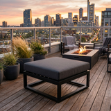 Charcoal ottoman cushion on a black metal frame on a city rooftop deck