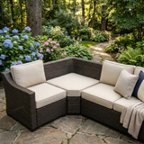 Cream angled cushions on a dark wicker corner sofa on a patio