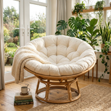 Cream tufted papasan cushion on a rattan chair by a garden door