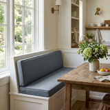 Slate blue seat and back cushions on a white built-in breakfast nook bench