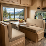 Beige cushions on the facing dinette benches of an RV beside a lake-view window