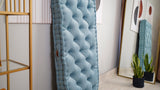 Side view of an upright light blue tufted floor mattress