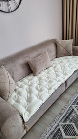 Ivory quilted linen sofa topper with tassels on a taupe sofa, made to measure by Foamera