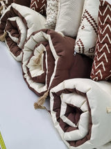 Rolled brown and cream quilted toppers with tassel ties