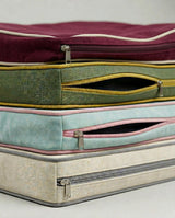 Close-up of open zippers on stacked cushion covers