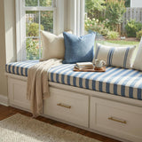 Blue and white striped trapezoid cushion on a window seat with drawers