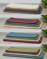 Four stacks of cushion covers in different color combinations
