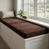 Chocolate brown corduroy cushion on a white window bench