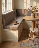 Taupe seat and back cushions with rust piping on a breakfast nook bench