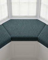 Teal chenille cushion on a bay window seat viewed from above