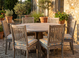 Striped tie-on seat cushions on teak dining chairs around a round table, made to measure by Foamera