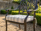 Striped tie-on cushion on a cast metal garden armchair