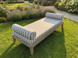 White striped daybed cushion with two bolsters on a lawn