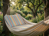 Striped cushion in a fabric hammock under trees