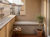 Brown striped cushion on a built-in balcony bench