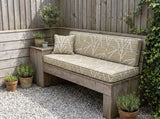 Beige geometric seat and back cushions on a rustic wooden bench