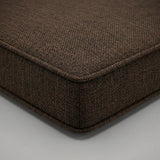 Close-up of a brown woven outdoor cushion corner with self piping