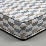 Blue and taupe geometric outdoor cushion with piping