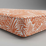 Orange and white leaf-print outdoor cushion corner
