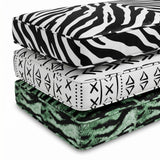 Stacked cushions in zebra, mud-cloth and green tiger prints