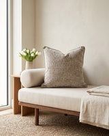 Taupe textured pillow on a daybed with a bolster