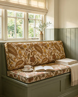 Close view of gold paisley seat and back cushions on a sage bench