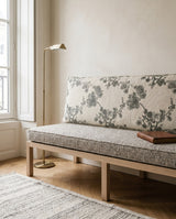 Gray floral back cushion and textured seat cushion on an oak bench