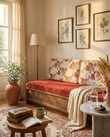 Rust floral back cushions and red seat cushion on a wooden bench