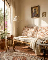 Rust floral cushions on a bench below an arched window