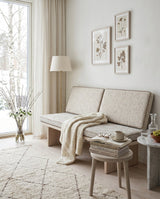 Cream bench cushion set on a white bench with a knit throw