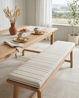 Cream striped cushion on an oak dining bench