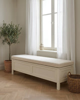 Cream boucle cushion on a white storage bench