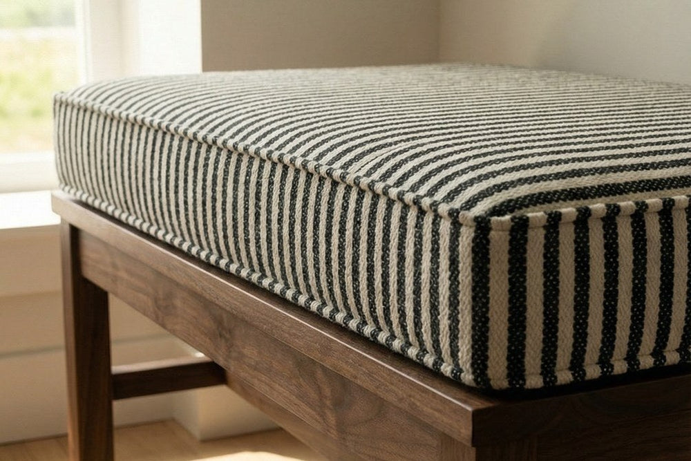 Striped custom bench cushion on a wooden bench