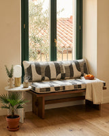 Geometric seat and back cushions on a walnut bench